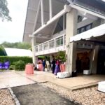 Outdoor event at modern white pavilion