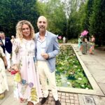 Couple posing by lily-pad pond in garden