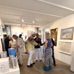 Visitors mingling at contemporary art exhibition