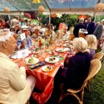 Guests enjoying colorful outdoor tented dinner