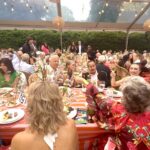 Guests dining at outdoor tented banquet